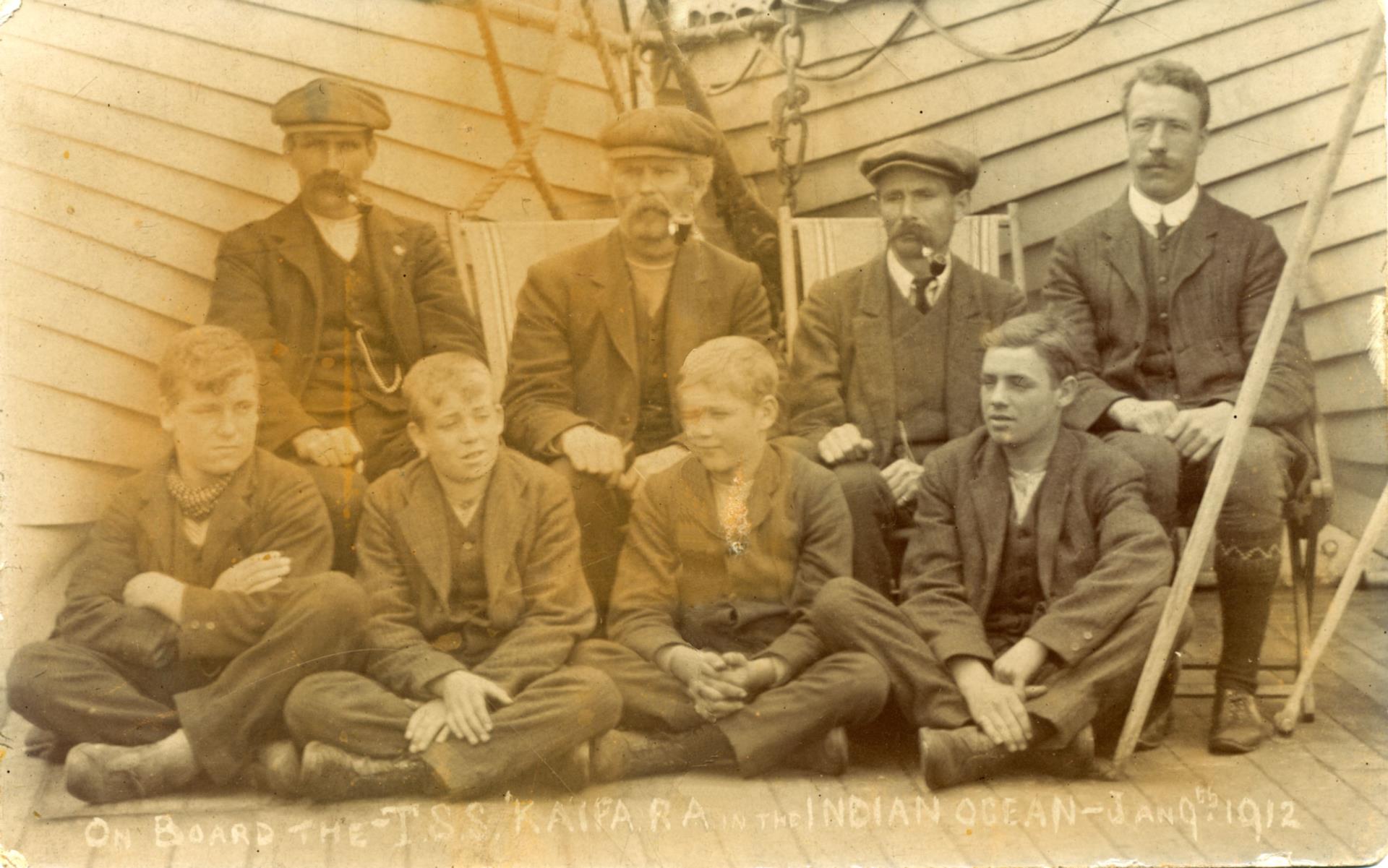 One of self proclaimed ‘Four terrors of the Kaipara’, Arthur sits with legs and arms crossed, far left, on the voyage to Australia.