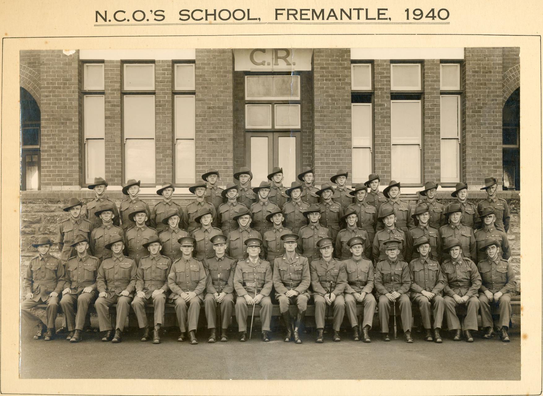 At the Non-commissioned Officer [NCO] school, Pte William Taylor stands in the back row, second from the left.