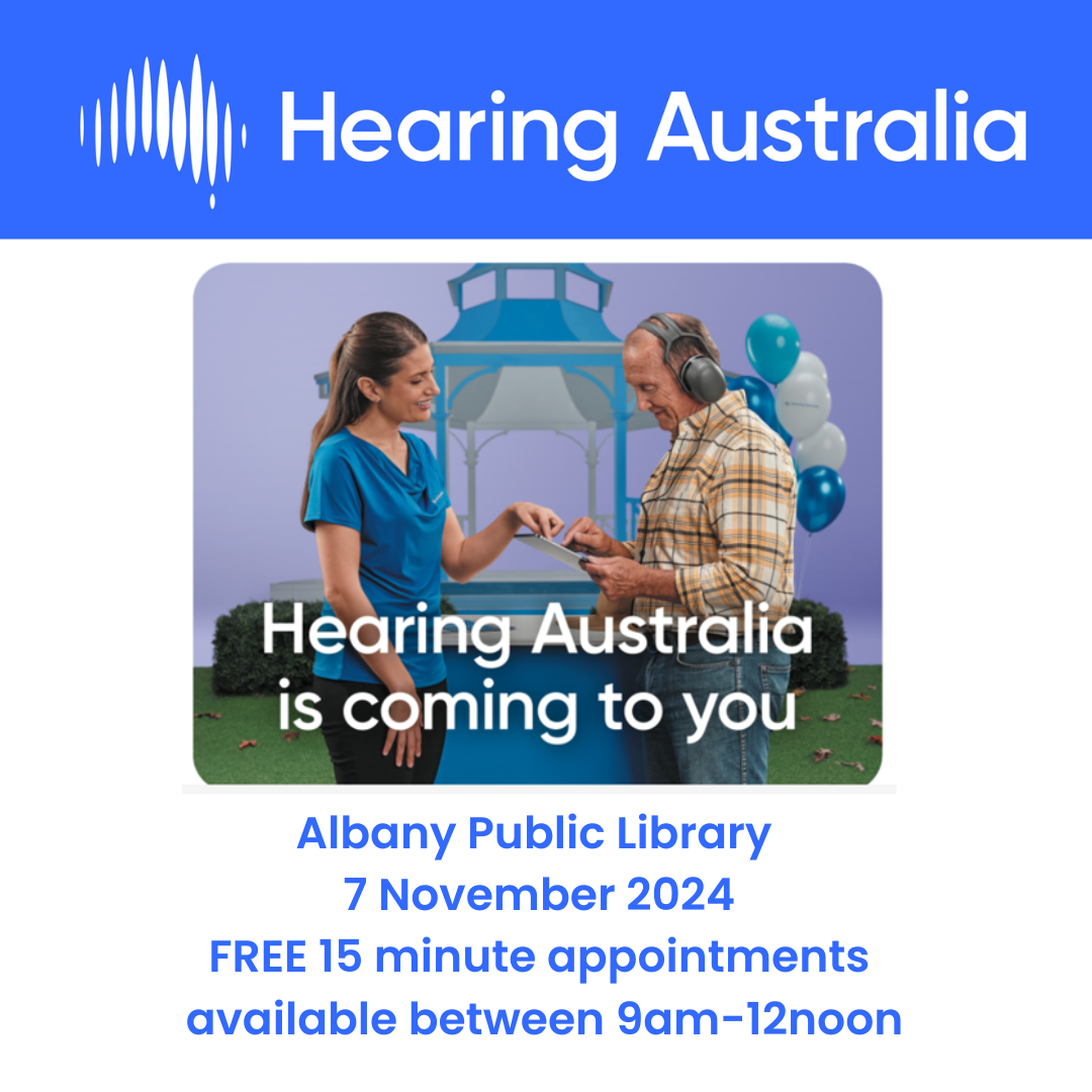 Photo of young woman conducting hearing check with older man wearing headphones